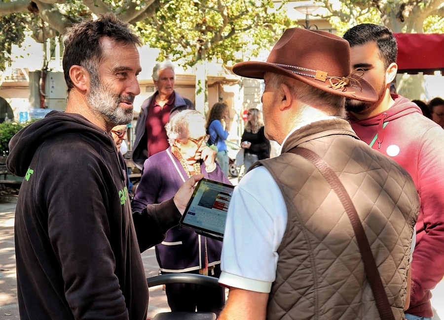 A group of colleagues gathered outdoors reviewing programme information
